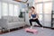 Vigorous energetic woman doing exercise at home with sport.