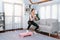 Vigorous energetic woman doing exercise at home with sport.