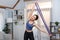 Vigorous energetic woman doing exercise at home with sport band.