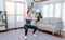 Vigorous energetic woman doing squat weight lifting exercise at home.