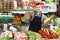 Vigorous male seller showing assortment of grocery shop