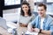 Vigorous young woman and man sitting at the table together