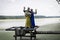 Viking family - father, mother and teenage daughter stand on a pier on the lake.