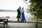 Viking family meets father on wooden walkways over the lake. Daughter hugs father.