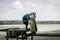 Viking family stands on a pier on a lake in the summer time. a man hugs his wife and daughter.