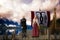 Viking man and woman standing on a pier by a long boat. 3D rendering