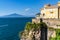 Villa on the rocks surrounded by the sea under a blue sky in Sorrento, Italy