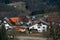 Village in the Alps in Germany in spring with green meadows and forest. Typical country houses with tile roofs surrounded a lot of