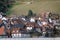 Village in the Alps in Germany in spring in valley. Typical country houses with tile roofs surrounded a lot of greenery