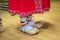 Village bast shoes made of bast worn on woolen socks women, part of the beautiful national pattern of the red skirt. Clothes, shoe