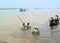 village children from a Cambodian fishing village, swim in metal basins on Tonle Sap Lake -Siem Reap, Cambodia 02/21/2011 .