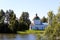 Village church in the background of a lake on a summer day