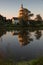 Village church with pond at sunset with reflection