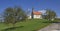 Village church in rural landscape with apple orchard