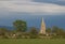 Village church in sunlight, dark skies behind