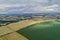 Village country farming shapes in field aerial drone photo