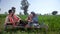 A village couple sitting on a woven cot in the village - modern village couple, modern lifestyle