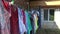 In a village courtyard, after washing, the laundry dries on a rope, fastened to it with multi-colored plastic clothespins.