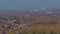 Village, forest and industrial plant with smoking chimney near Mons