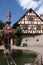 Village fountain with with half-timbered house