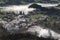 Village of Furnas at sunrise with a fog mist of gases and steams from several fumaroles, calderas and thermal pools