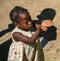 Village girl plays with bubbles in rural Haiti.