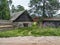 Village house with a facade facing cobblestones near the road