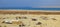 Village huts of a nomad camp in the desert near the sea in the M