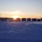 Village on ice.  Sunset. Snow. Withe. Orange.  Sky.