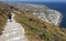 The village of Kamari in the island of Santorini, Greece, seen from way above at the entrance of the Ancient Village of Thera in a