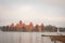 Village of Karaites, Lithuania, Europe. Lithuanian landmark in late autumn. The view to pier and yacht sailing at lake near Trakai