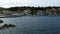 The Village of Kassiopi, Corfu Island, Greece. Rocky coast of Ionian Sea and houses on the hill