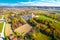 Village of Komin church and green landscape aerial view