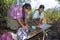 Village life Indian mother and daughter wash laundry