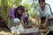 Village life Indian mother and daughter wash laundry