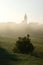 Village And Meadow In Misty Morning