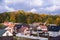 The village near the forest. New private homes. Beautiful autumn forest and roofs of the houses