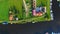 Village near the river. Drone camera vertical tilt over the small village near the river on a countryside on a sunny summer day.