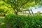 Village park goalposts seen stacked and leaning against a hedge located at the side of a village park