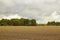 Village plowed field on a cloudy day