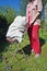 Village poor woman collect old rubbish metal and plastic  and are taken out on a wheelbarrow