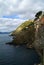 Village of Riomaggiore, rocks and sea covered by clouds. Cinque Terre, Italy