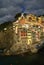 Village of Riomaggiore, rocks and sea covered by clouds. Cinque Terre, Italy