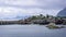 A village on the rocky shore of the fjord in Norway