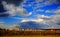 The village at the setting sun and sky with storm clouds