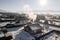 Village in Siberia during day. The view from the top. Many wooden houses in the countryside with stove heating. Frosty