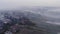 Village is in the smoke, atmospheric pollution, burning weeds on the field. Autumn time, Ukraine. Aerial view from drone