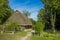 Village wooden cabin spring time sunny weather outdoor garden nature environment vivid green color foliage and blue sky background