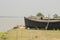 villagers resting under the shade of fishing boat