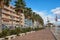 Villajoyosa, Spain - November 24, 2019: Facades of houses and avenue of palm trees on the pedestrian promenade of the sea